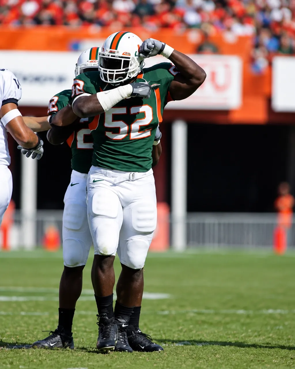 Miami Hurricanes player wearing number 52 celebrating on the field